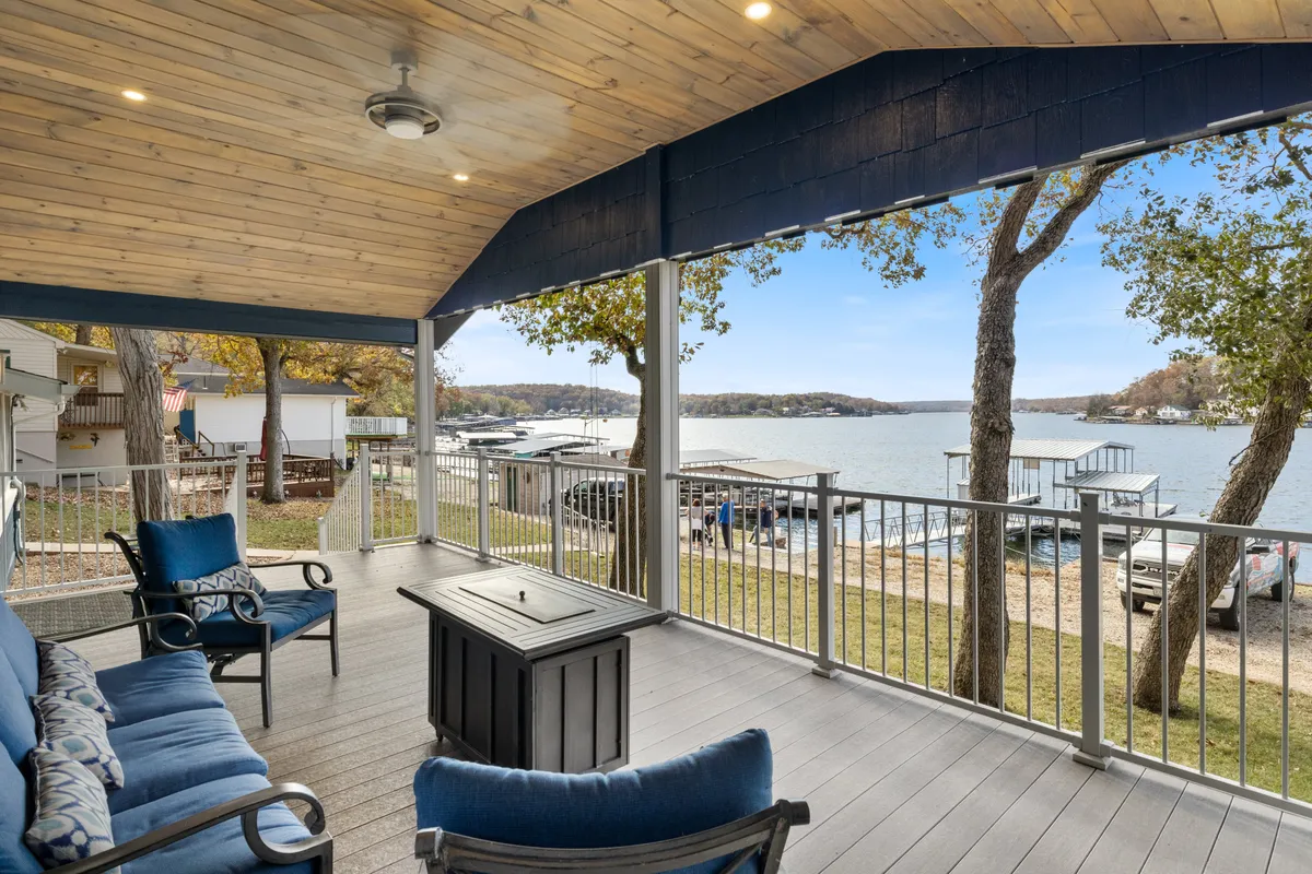 An inviting outdoor seating area arranged beside a fire pit, overlooking the shimmering lake. The comfortable chairs are positioned to savor the sunset, encouraging relaxation and conversation while enjoying the beauty of the water.